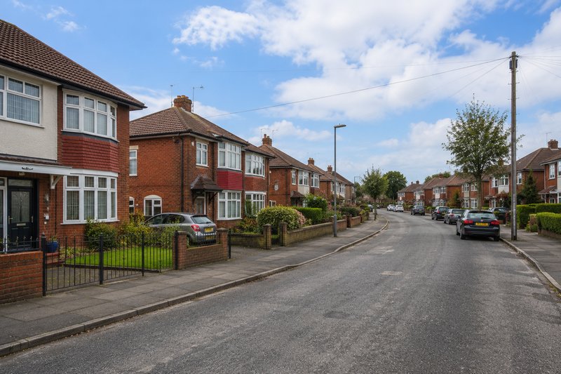 A typical Halewood residential street showing semi-detached and terraced red-brick homes